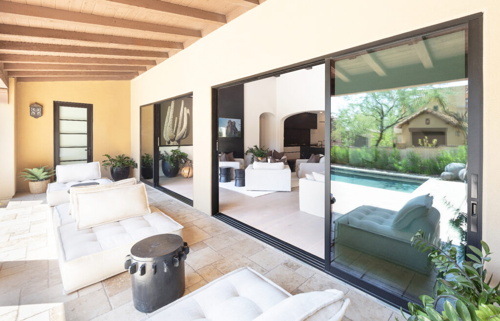 Double multi-slide doors create multiple connections from patio to great room