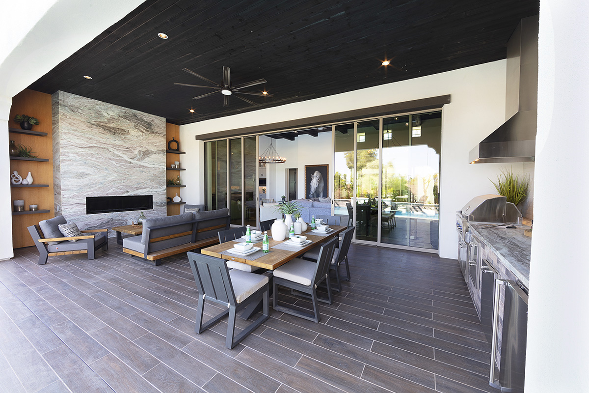An outdoor seating and dining area connects to the living room with bi-parting sliding doors.